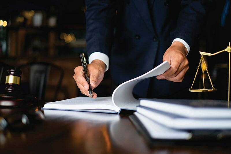 a man holding a pen and a paper