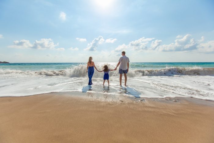 a family walking on the beach