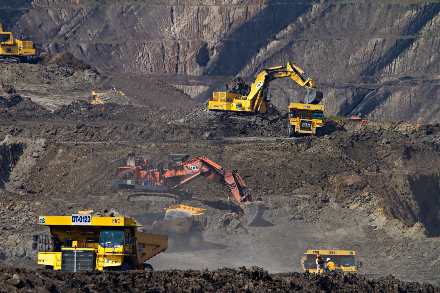 a group of construction vehicles in a quarry