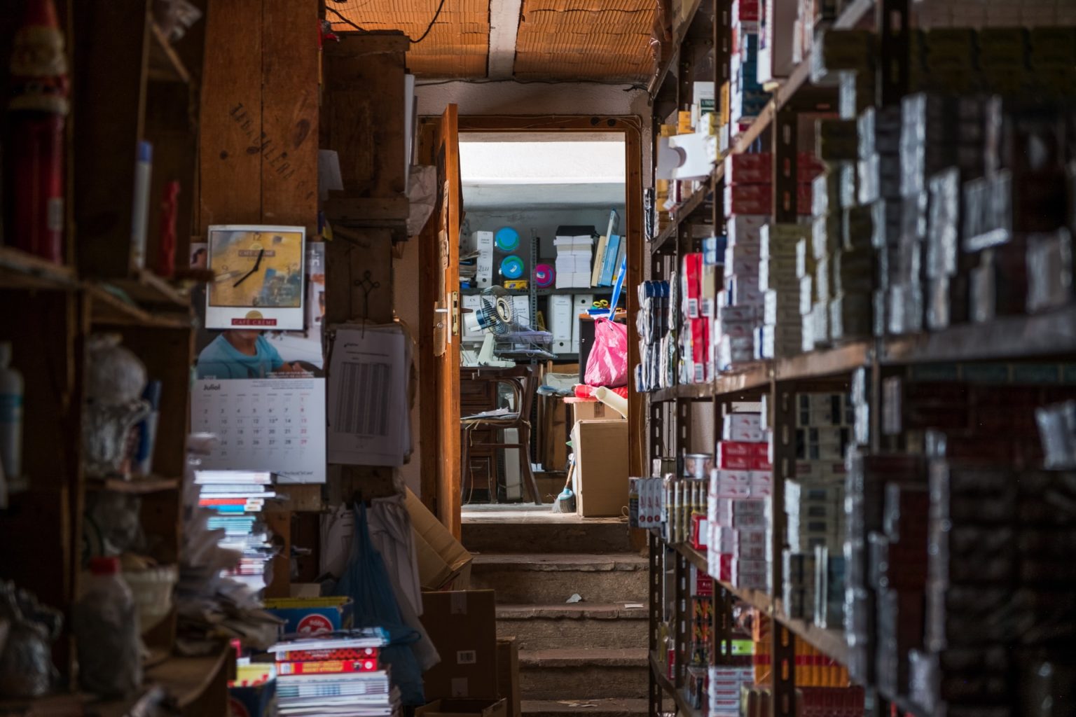 a room with shelves and books