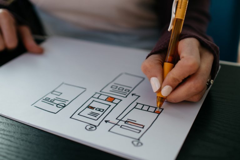 a person drawing on a piece of paper