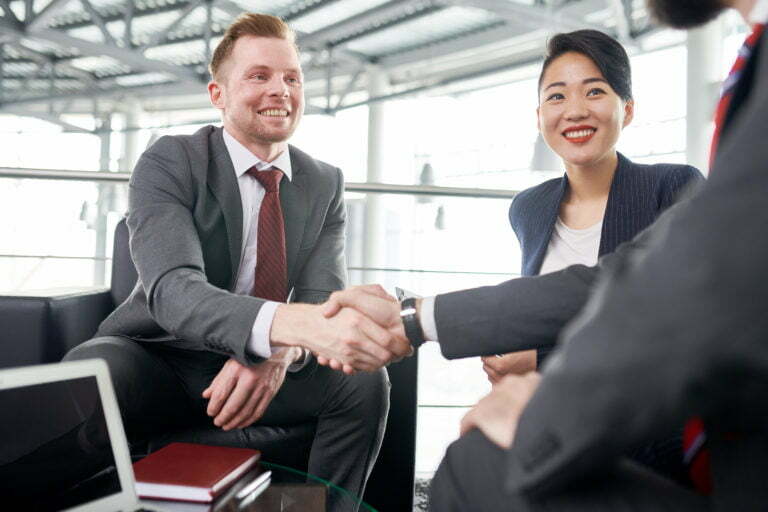 a man shaking hands with a woman