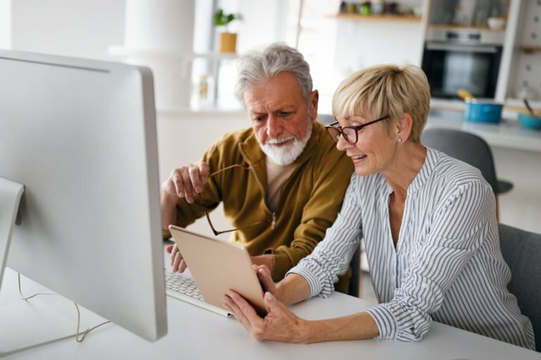 a man and woman looking at a computer screen