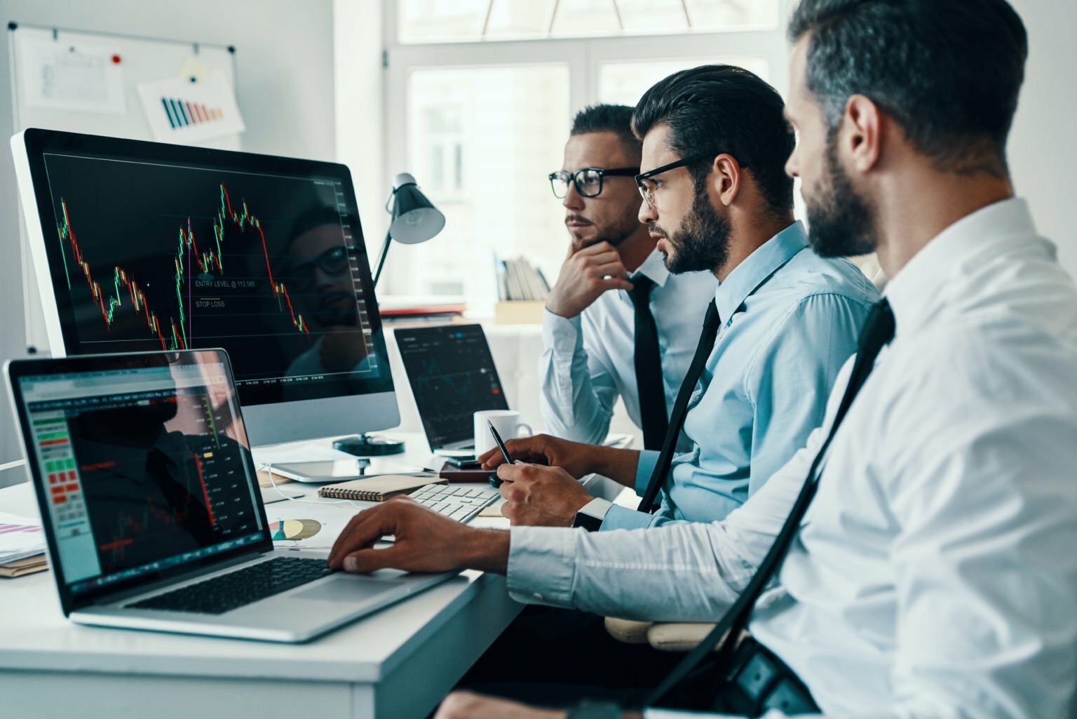 a group of people looking at a computer screen