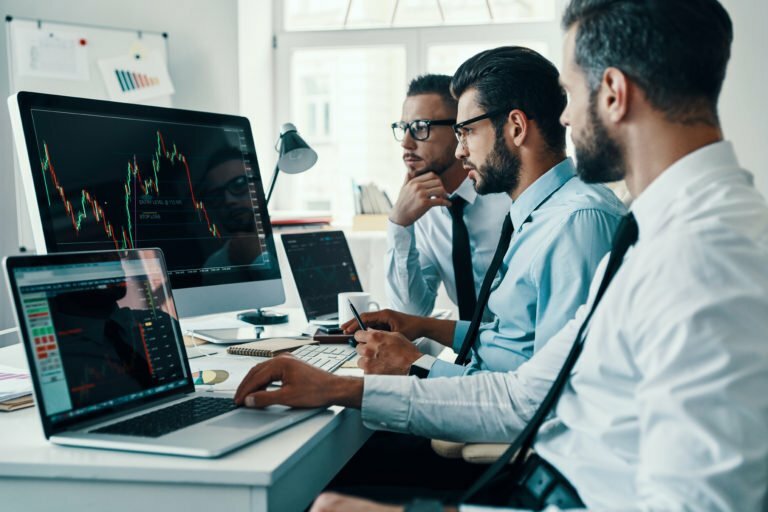a group of people looking at a computer screen