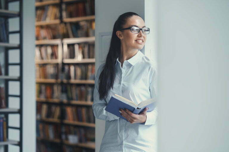 young woman standing by a door