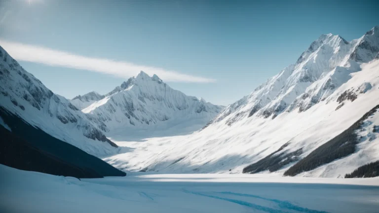 a serene alaskan landscape with towering snow-capped mountains and a clear blue sky.